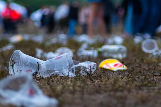plastic waste on the ground at a music festival